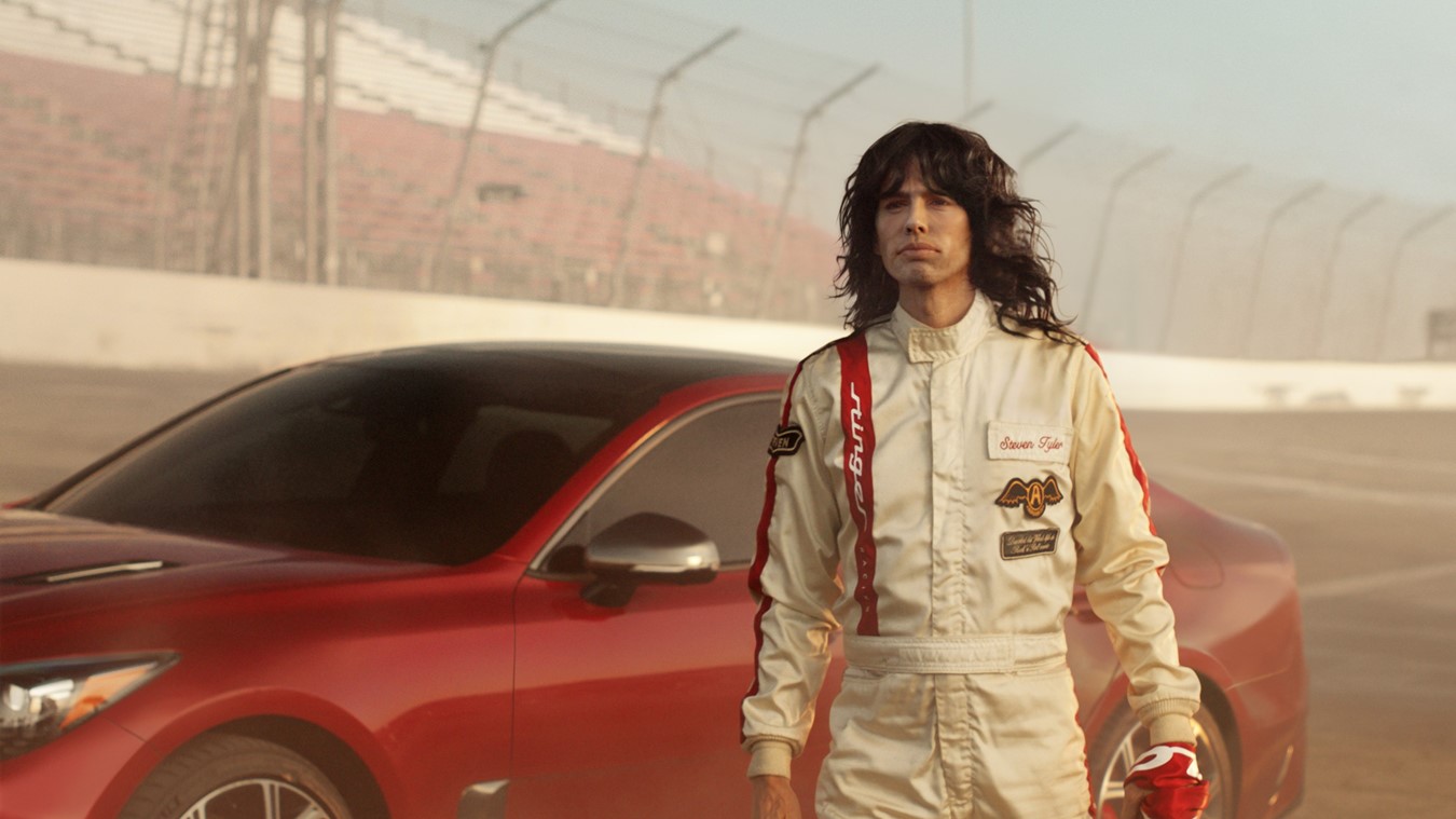 The all-new 2018 Kia Stinger GT’s twin-turbo, 365-horsepower engine is put to use – in reverse – sending Steven Tyler on a transformative journey back to the seventies.  